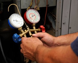Manifold gauges in technician's hands image